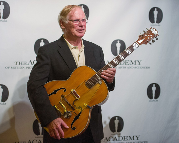 Vic Flick holding the Clifford Essex Paragon DeLuxe at an Oscar Bond music tribute evening in 2013